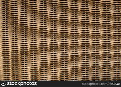 Natural brown rattan woven furniture surface closeup as background