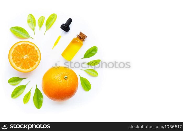 Natural citrus oil with fresh orange fruit and green leaves on white background. High vitamin C. Top view