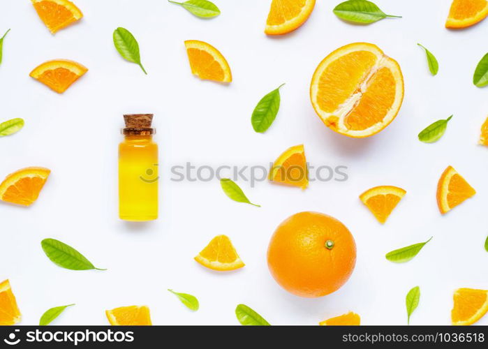 Natural citrus oil with fresh orange fruit and green leaves on white background. High vitamin C. Top view