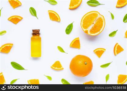 Natural citrus oil with fresh orange fruit and green leaves on white background. High vitamin C. Top view