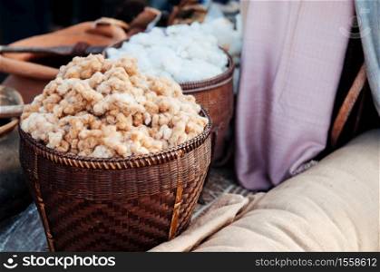 Natural colour cotton fiber in Asian style bamboo basket local Thai cotton fabric making in rural area