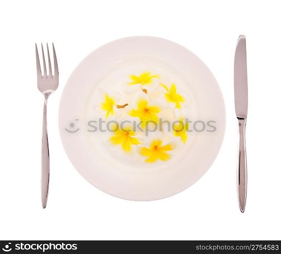 Natural concept, flowers on white plate with fork and knife isolated on white background