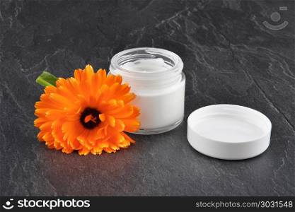 Natural cosmetics and common marigold on shale