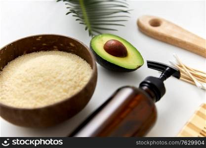 natural cosmetics, sustainability and eco living concept - avocado, sea salt in bowl, liquid soap or shower gel and cotton swabs on white background. natural cosmetics and bodycare items