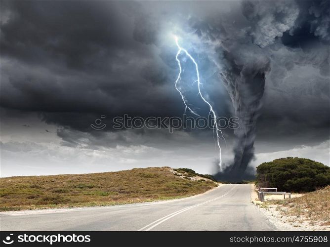 Natural disaster. Powerful tornado and lightning above countryside road