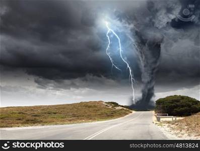 Natural disaster. Powerful tornado and lightning above countryside road