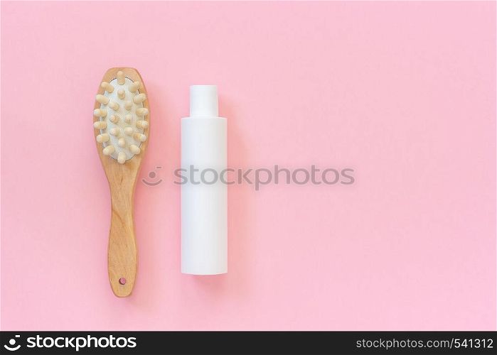 Natural eco brush and white bottle of cream for massage, peeling and body care. Concept of beautiful, healthy body and fight against cellulite. Template Copy space Top view.. Natural eco brush and white bottle of cream for massage, peeling and body care. Concept of beautiful, healthy body and fight against cellulite. Template Copy space Top view
