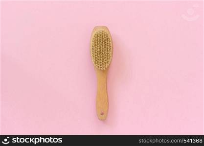 Natural eco brush for massage, peeling and body care on pink paper background. Concept of beautiful, healthy body and fight against cellulite. Template Copy space Top view.. Natural eco brush for massage, peeling and body care on pink paper background. Concept of beautiful, healthy body and fight against cellulite. Template Copy space Top view