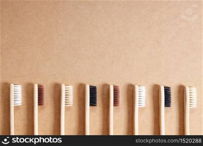 natural eco friendly toothbrush with wooden bamboo handle on brown background.