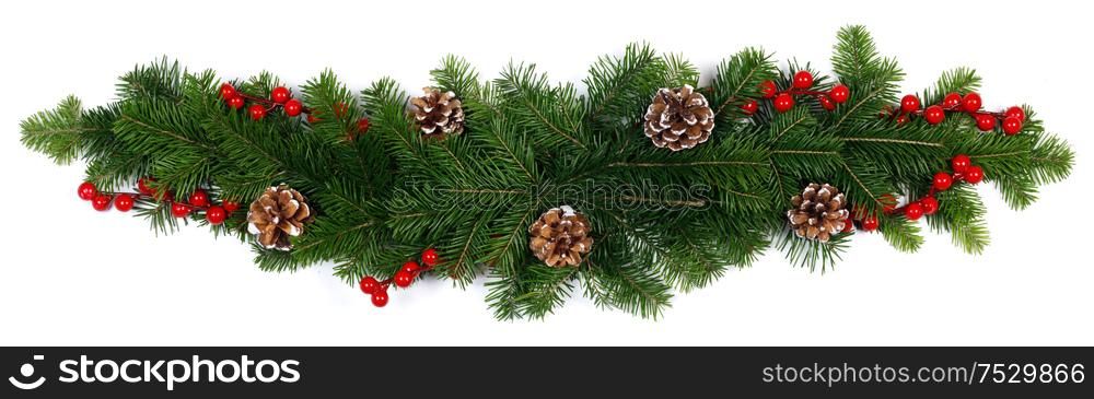 Natural fir Christmas tree branches, cones and red berries isolated on white , copy space for text. Fir tree branch decor on white