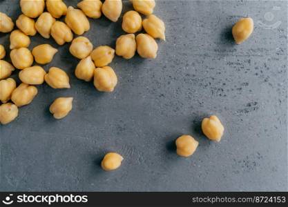 Natural food ingredients and healthy eating concept. Dry raw chickpeas on dark background. Protein food. Healthy nutrition concept