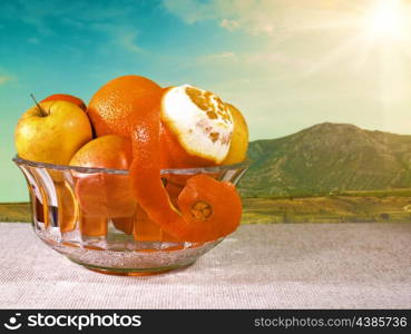 Natural food still life. Bowl with fresh fruits on the desk