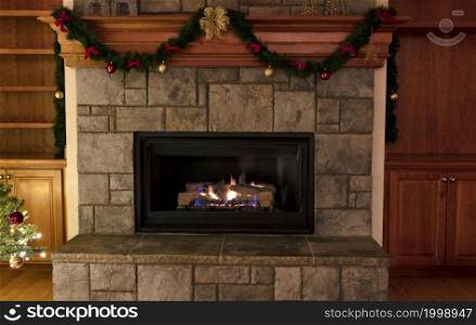 Natural gas insert fireplace, ceramic logs, decorated for a Merry Christmas or a Happy New Year concept