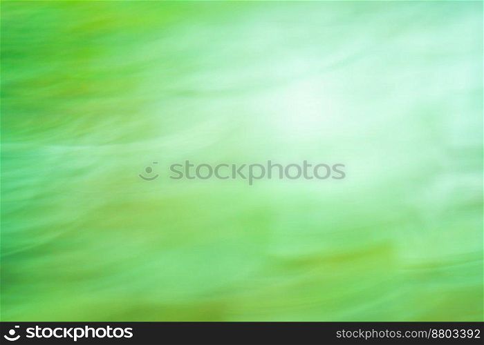 Natural green blurry defocused dynamic abstract background. Fresh spring green high speed motion blurred background.. Green fast speedy motion. Green slow shutter speed with motion blur effect.