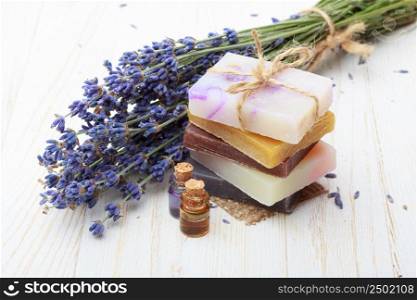Natural handmade soap with lavender and essential oil on wooden table