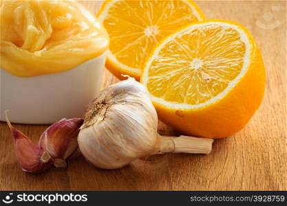 Natural healing, alternative medicine. Healthy ingredients for strengthening immunity. Honey garlic and lemon on wooden rustic table.
