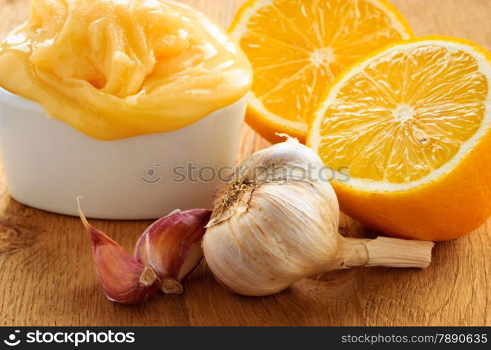 Natural healing, alternative medicine. Healthy ingredients for strengthening immunity. Honey garlic and lemon on wooden rustic table.