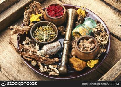 Natural herbal medicine.Medicinal herbs and ingredients on vintage wooden background.. Medicinal herbs and roots