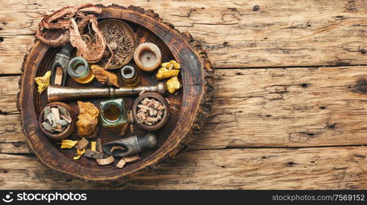 Natural herbal medicine sets on old wooden table. Healing herbs and medicinal bottles