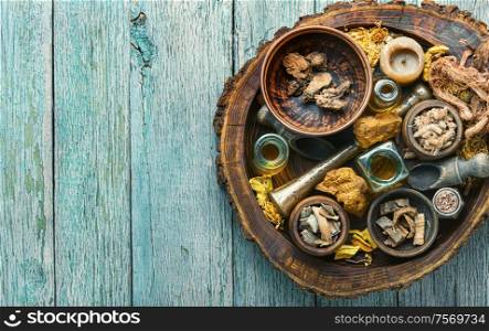 Natural herbal medicine sets on old wooden table. Healing herbs and medicinal bottles