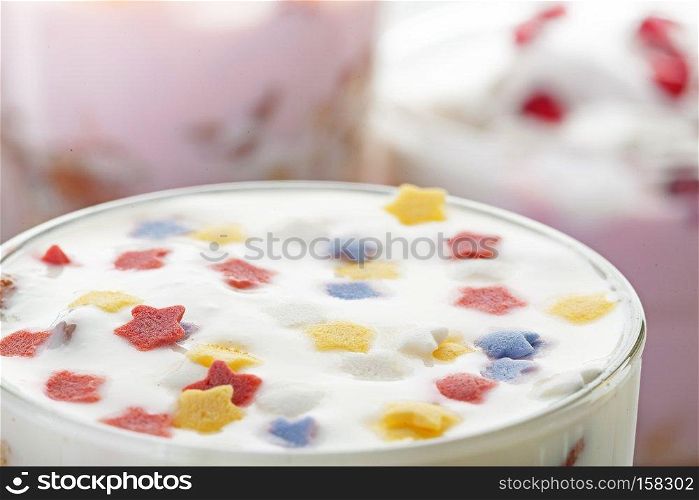 Natural homemade yogurt decorated with multicolored stars. Homemade yogurt meal with fruits, selective focus.