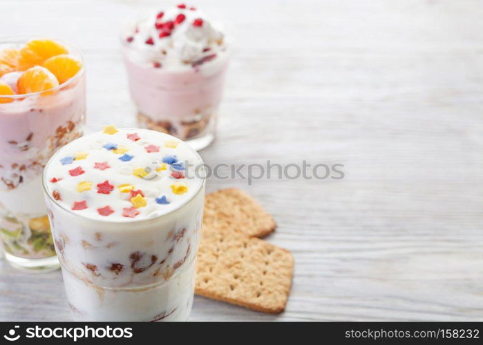 Natural homemade yogurt with fruits on a white wooden background, selective focus, copy space. Homemade yogurt meal with fruits, selective focus