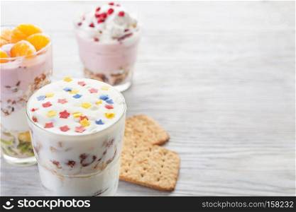 Natural homemade yogurt with fruits on a white wooden background, selective focus, copy space. Homemade yogurt meal with fruits, selective focus