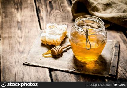 Natural honey on a wooden Board. On wooden background.. Natural honey on a wooden Board.