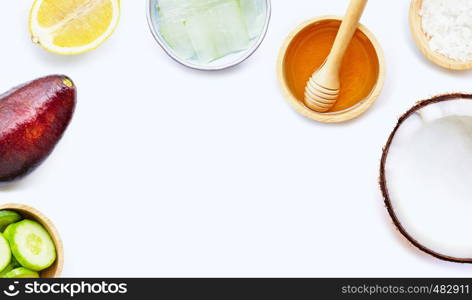 Natural ingredients for homemade skin care on white background.