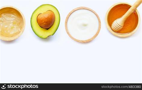 Natural ingredients for homemade skin care on white background.