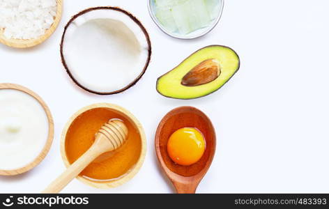 Natural ingredients for homemade skin care on white background.