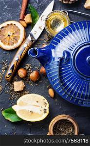 Natural ingredients for tea.Porcelain blue teakettle.Useful tea with lemon.. Tea with lemon