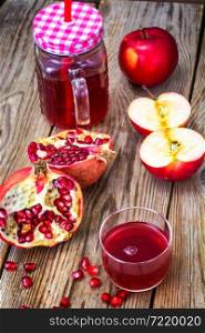 Natural juice of pomegranate and red apples. Stidio Photo. Natural juice of pomegranate and red apples