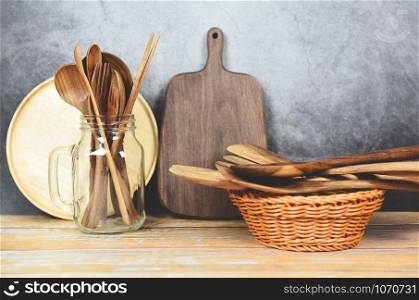Natural kitchen tools wood products / Kitchen utensils background with spoon fork chopsticks plate cutting board object utensil wooden concept , selective focus