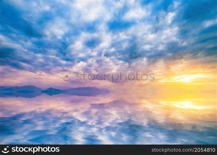 natural landscape with cloudy sky at sunset reflected in water. sky at sunset reflected in water