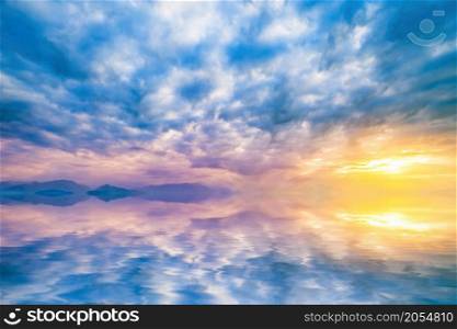 natural landscape with cloudy sky at sunset reflected in water. sky at sunset reflected in water