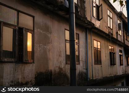 Natural light from sunrise lit rustic old buildings in the dark