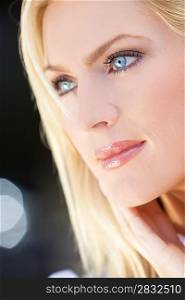 Natural light portrait of a beautiful blond woman with blue eyes