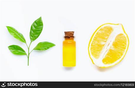 Natural oil with lemon and citrus green leaves on white background. High vitamin C.