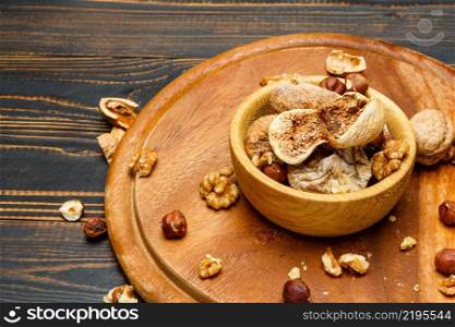 natural organic dried figs and nuts on wooden background. dried figs and nuts on wooden background