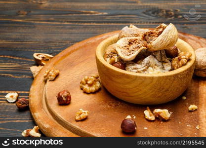 natural organic dried figs and nuts on wooden background. dried figs and nuts on wooden background