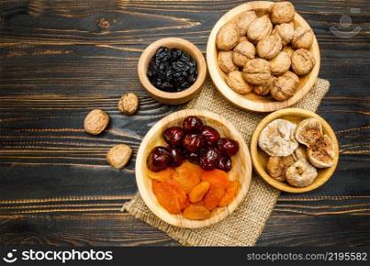 natural organic dried fruits and nuts on wooden background. dried fruits figs, apricots, plums and nuts on wooden background