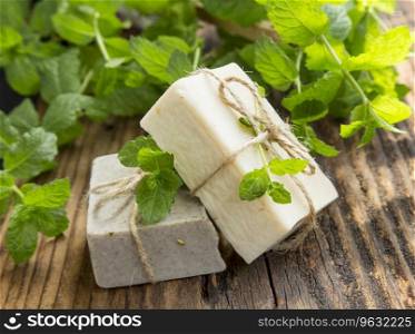 Natural organic mint soaps with mint leaves on wooden background