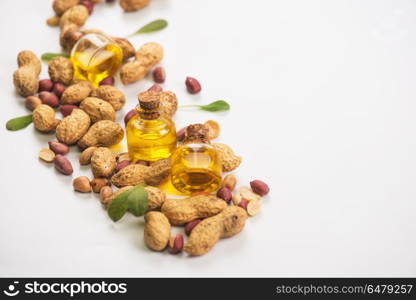 Natural peanut with oil in a glass. Natural peanuts with oil in a glass jar on a white background