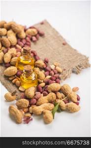 Natural peanut with oil in a glass. Natural peanuts with oil in a glass jar on a white background