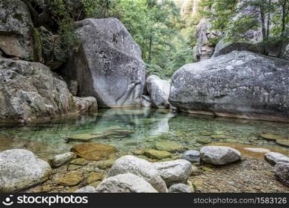 Natural pool in the famous Purcaraccia Canyon in Bavella during summer, a tourist destination and attraction for many outdoor activities. Corsica, France. Purcaraccia Canyon in Bavella, Corsica. France