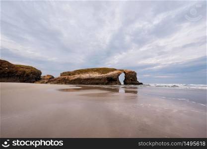 Natural rock arch in beach of Cathedrals in Lugo, Galicia, Spain.