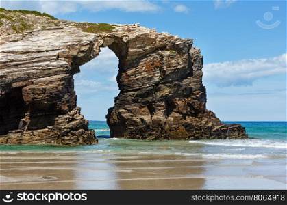 Natural rock arch on Cathedrals beach in low tide (Cantabric coast, Lugo (Galicia), Spain).
