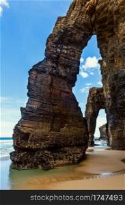 Natural rock arches on Cathedrals beach in low tide  Cantabric coast, Lugo  Galicia , Spain .