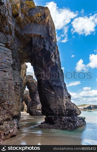 Natural rock arches on Cathedrals beach in low tide (Cantabric coast, Lugo (Galicia), Spain).